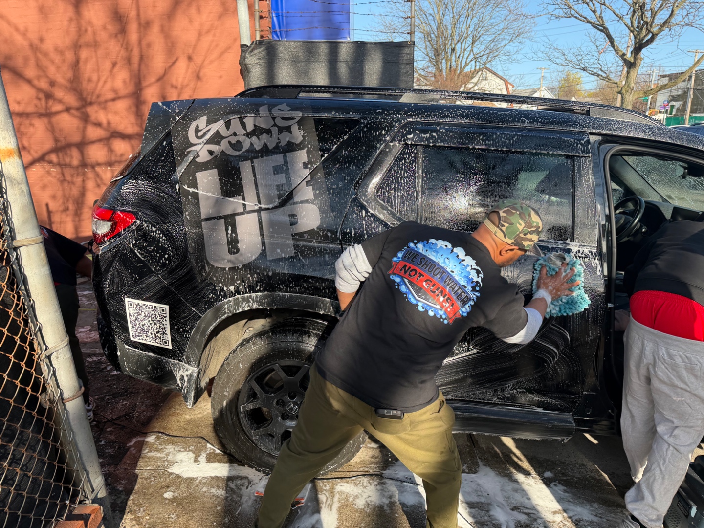 BLK Squares team hand washing an SUV