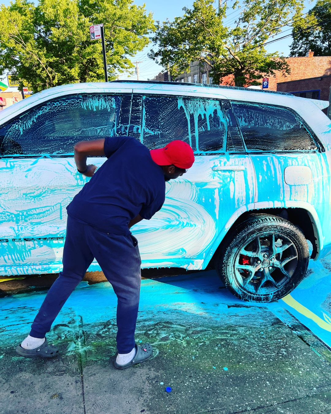 BLK Squares staff detailing a white SUV with blue foam